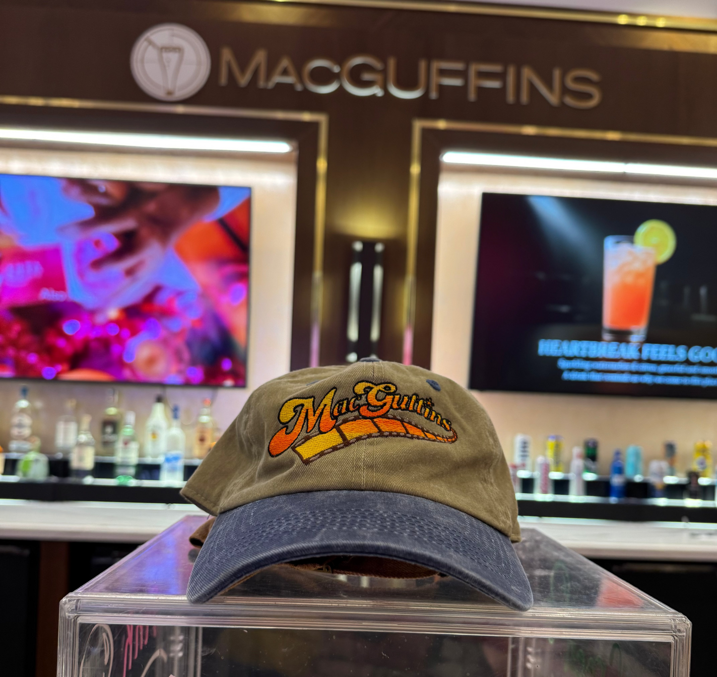 MacGuffins cap on a clear stand 